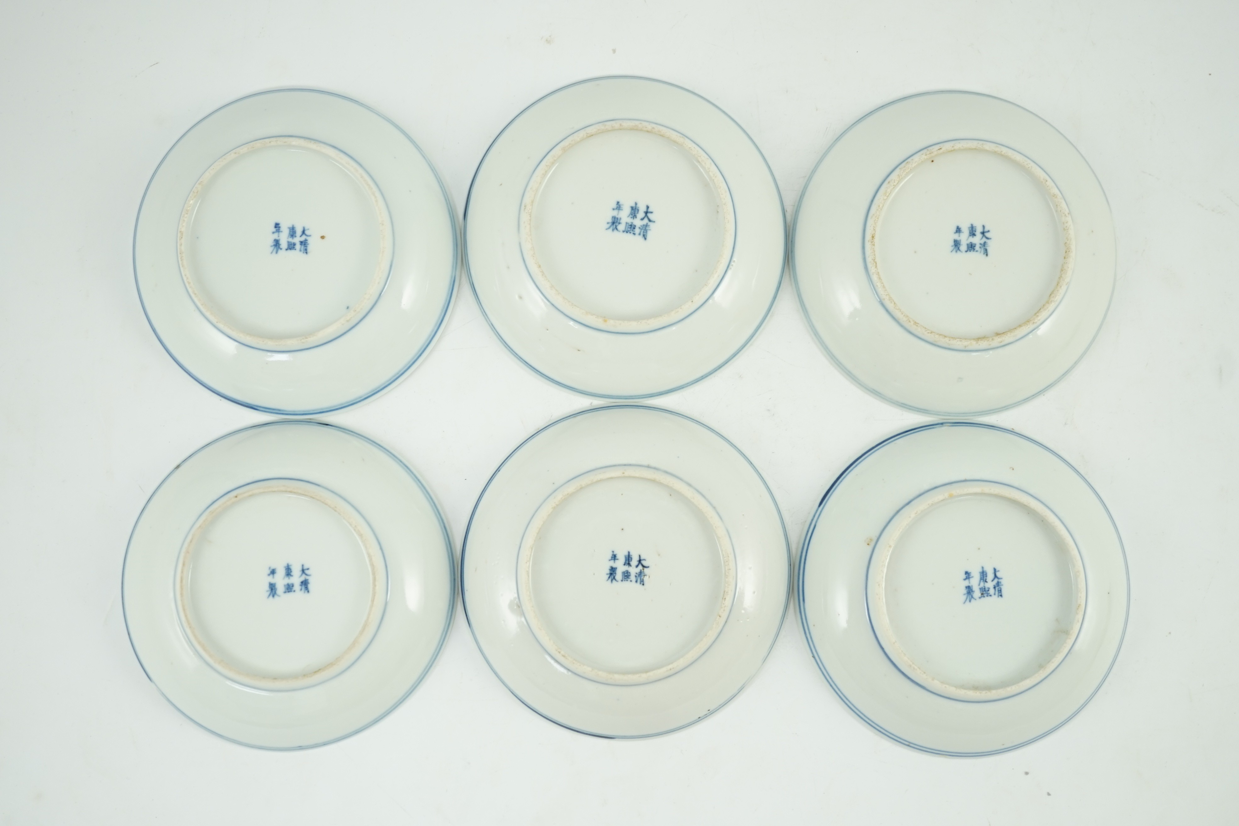 A set of six Chinese ‘Seven Sages of the Bamboo Grove’ saucer dishes, Kangxi marks but late 19th century, 12.3cm diameter